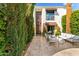 Welcoming patio with comfortable outdoor seating, mature landscaping, and architectural details at 7242 E Joshua Tree Ln, Scottsdale, AZ 85250