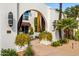 Charming exterior view with covered patio, beautiful landscape, and comfortable seating area at 7242 E Joshua Tree Ln, Scottsdale, AZ 85250
