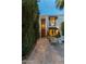 Home with a decorative wood door, exterior lighting, and a cozy outdoor seating area at 7242 E Joshua Tree Ln, Scottsdale, AZ 85250