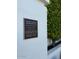 Sands North Townhouses historical marker on a white exterior wall near lush greenery at 7242 E Joshua Tree Ln, Scottsdale, AZ 85250