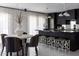Modern kitchen featuring sleek, dark cabinets, a stylish island, and elegant lighting at 7242 E Joshua Tree Ln, Scottsdale, AZ 85250