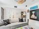 Sleek living room features a modern screen wall, a gray sofa, and unique artwork at 7242 E Joshua Tree Ln, Scottsdale, AZ 85250
