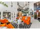 Spacious living room featuring an orange sofa, high ceilings, and an open floor plan at 7242 E Joshua Tree Ln, Scottsdale, AZ 85250