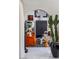 Stylish living room view through archway boasts modern decor and inviting orange couches at 7242 E Joshua Tree Ln, Scottsdale, AZ 85250