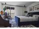 Comfortable main bedroom featuring a plush bed, stylish decor, and natural light from the balcony view at 7242 E Joshua Tree Ln, Scottsdale, AZ 85250