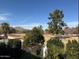 Neighborhood view overlooking greenery and a mountain backdrop on a clear blue day at 7242 E Joshua Tree Ln, Scottsdale, AZ 85250