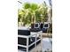 Stylish outdoor seating area with modern furniture, set against a backdrop of lush greenery at 7242 E Joshua Tree Ln, Scottsdale, AZ 85250