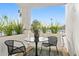 Inviting patio features black metal table, chairs, plants and views of the clear blue sky at 7242 E Joshua Tree Ln, Scottsdale, AZ 85250