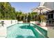Inviting swimming pool offers a tranquil oasis with privacy landscaping and modern features at 7242 E Joshua Tree Ln, Scottsdale, AZ 85250