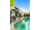 A backyard patio features lush landscaping and a long pool, creating a perfect outdoor retreat at 7242 E Joshua Tree Ln, Scottsdale, AZ 85250