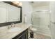 Bathroom with a granite countertop, decorative mirror, and shower over tub at 7401 N Scottsdale Rd # 24, Paradise Valley, AZ 85253