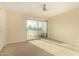 Sunny bedroom features a ceiling fan, a closet, and sliding doors to a private balcony at 7755 E Thomas Rd # 7, Scottsdale, AZ 85251