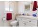 Cozy bathroom featuring a white vanity, toilet, and a bright window for natural light at 7807 E Main St # Aa-8, Mesa, AZ 85207