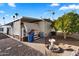 Exterior view of the home featuring low maintenance yard, shed, and air conditioning unit at 7807 E Main St # Aa-8, Mesa, AZ 85207