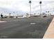 Wide street view showcasing the mobile home community with palm trees under a cloudy sky at 7807 E Main St # Aa-8, Mesa, AZ 85207
