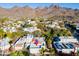 Scenic aerial view of the home with mountain backdrop, lush greenery, and community at 7841 N 18Th St, Phoenix, AZ 85020