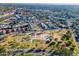 Aerial view of a residential neighborhood featuring a green park, roads, houses, and the city skyline at 7841 N 18Th St, Phoenix, AZ 85020