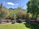 Manicured backyard with a bird bath, desert landscaping, and mountain views at 7841 N 18Th St, Phoenix, AZ 85020