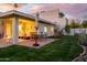 Expansive backyard with a covered patio, outdoor seating, dining area, lush lawn and desert landscaping at 7841 N 18Th St, Phoenix, AZ 85020