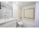 White bathroom with a combination bathtub and shower with decorative blue accent tiles at 7841 N 18Th St, Phoenix, AZ 85020