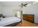 Bright bedroom featuring a ceiling fan, a wooden dresser, and access to a private patio and bathroom at 7841 N 18Th St, Phoenix, AZ 85020