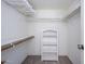 Walk-in closet with white shelves, rails for hangers, and carpet flooring providing ample storage space at 7841 N 18Th St, Phoenix, AZ 85020