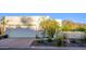 Beige single-story home with a two-car garage, desert landscaping, and mountain views at 7841 N 18Th St, Phoenix, AZ 85020