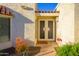 Home's entrance with a beige double door, desert landscaping and a decorative light fixture at 7841 N 18Th St, Phoenix, AZ 85020