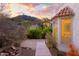 Charming home exterior with a walkway, beautiful landscaping, and a mountain backdrop at 7841 N 18Th St, Phoenix, AZ 85020