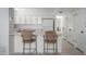 Kitchen featuring a breakfast bar with seating, white cabinets and appliances at 7841 N 18Th St, Phoenix, AZ 85020