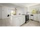 Open-concept kitchen boasts white cabinets, a breakfast bar, and overlooks the adjacent living area at 7841 N 18Th St, Phoenix, AZ 85020