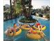 A group of people enjoy a leisurely float down a winding lazy river with lush tropical landscaping at 7841 N 18Th St, Phoenix, AZ 85020