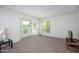 Bright living room featuring a bay window, neutral carpet, and a minimalist design at 7841 N 18Th St, Phoenix, AZ 85020