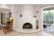 Living room features a white fireplace and tile floors, blending classic charm with modern comfort at 7841 N 18Th St, Phoenix, AZ 85020