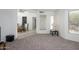 Open living room with tile floors, a large wall mirror and dining room access at 7841 N 18Th St, Phoenix, AZ 85020