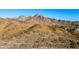 Scenic view of majestic mountains with brown and gray hues, accented by a winding road and sparse desert growth at 7841 N 18Th St, Phoenix, AZ 85020