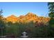 Scenic view of mountains with lush greenery and red flowers in the foreground against a clear blue sky at 7841 N 18Th St, Phoenix, AZ 85020