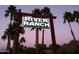 Entrance sign for River Ranch, featuring palm trees and illuminated lettering against a twilight sky at 7841 N 18Th St, Phoenix, AZ 85020