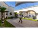 Community courtyard with seating areas and string lights, near a fenced pool, under a bright sky at 7920 E Camelback Rd # 303, Scottsdale, AZ 85251