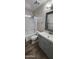 Bathroom features updated vanity with framed mirror and shower-tub combo at 846 W Straford Ave, Gilbert, AZ 85233