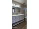 Modern bathroom features a white vanity with great storage, a large mirror, and shower/tub at 846 W Straford Ave, Gilbert, AZ 85233
