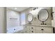 Bright bathroom featuring dual vanity, granite countertops, black hardware and separate tub and shower at 846 W Straford Ave, Gilbert, AZ 85233