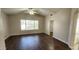 Bedroom features hardwood floors, natural light from a large window and ensuite bathroom and walk-in closet at 846 W Straford Ave, Gilbert, AZ 85233