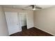 Clean bedroom featuring wood floors, closet space, and a ceiling fan at 846 W Straford Ave, Gilbert, AZ 85233