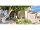 Charming home exterior with a large tree, desert landscaping, and a two-car garage at 846 W Straford Ave, Gilbert, AZ 85233