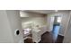 Hallway with hardwood floors, neutral walls, and stairs to a lower level featuring a decorative lighting fixture at 846 W Straford Ave, Gilbert, AZ 85233