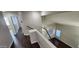 Second story landing with railing overlooking the first floor, hardwood floors, and a view of the staircase and rooms at 846 W Straford Ave, Gilbert, AZ 85233