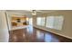 Open floor plan with a view of kitchen with island and stainless steel appliances from hardwood living area at 846 W Straford Ave, Gilbert, AZ 85233