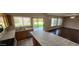 Bright kitchen and living area with marble counters, tile floors, hardwood floors and sliding glass doors to the backyard at 846 W Straford Ave, Gilbert, AZ 85233