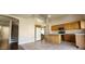 Vaulted kitchen featuring tile floors, an island, stainless steel appliances and access to the staircase at 846 W Straford Ave, Gilbert, AZ 85233